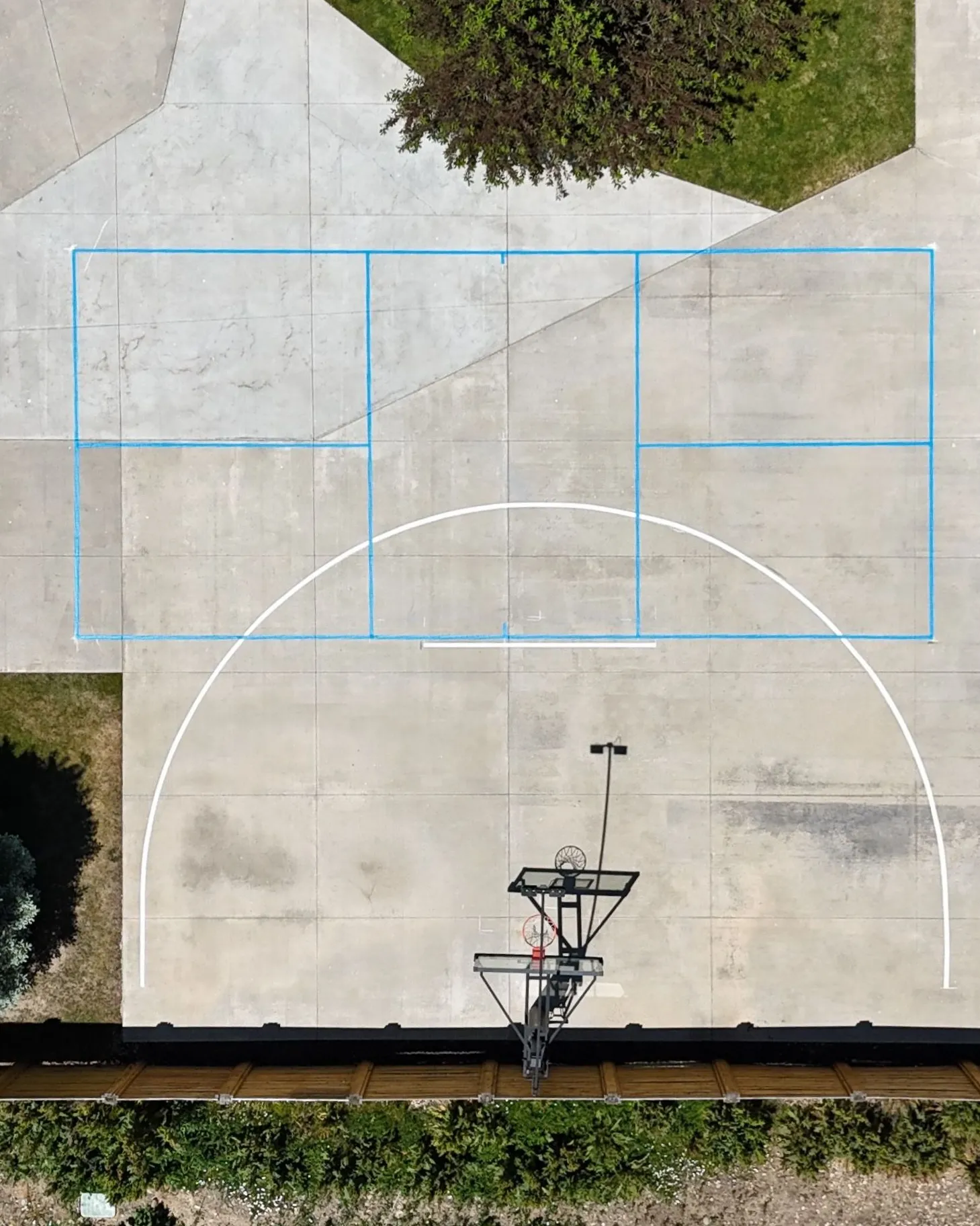 Aerial view of multi-sport court lines on a concrete pad