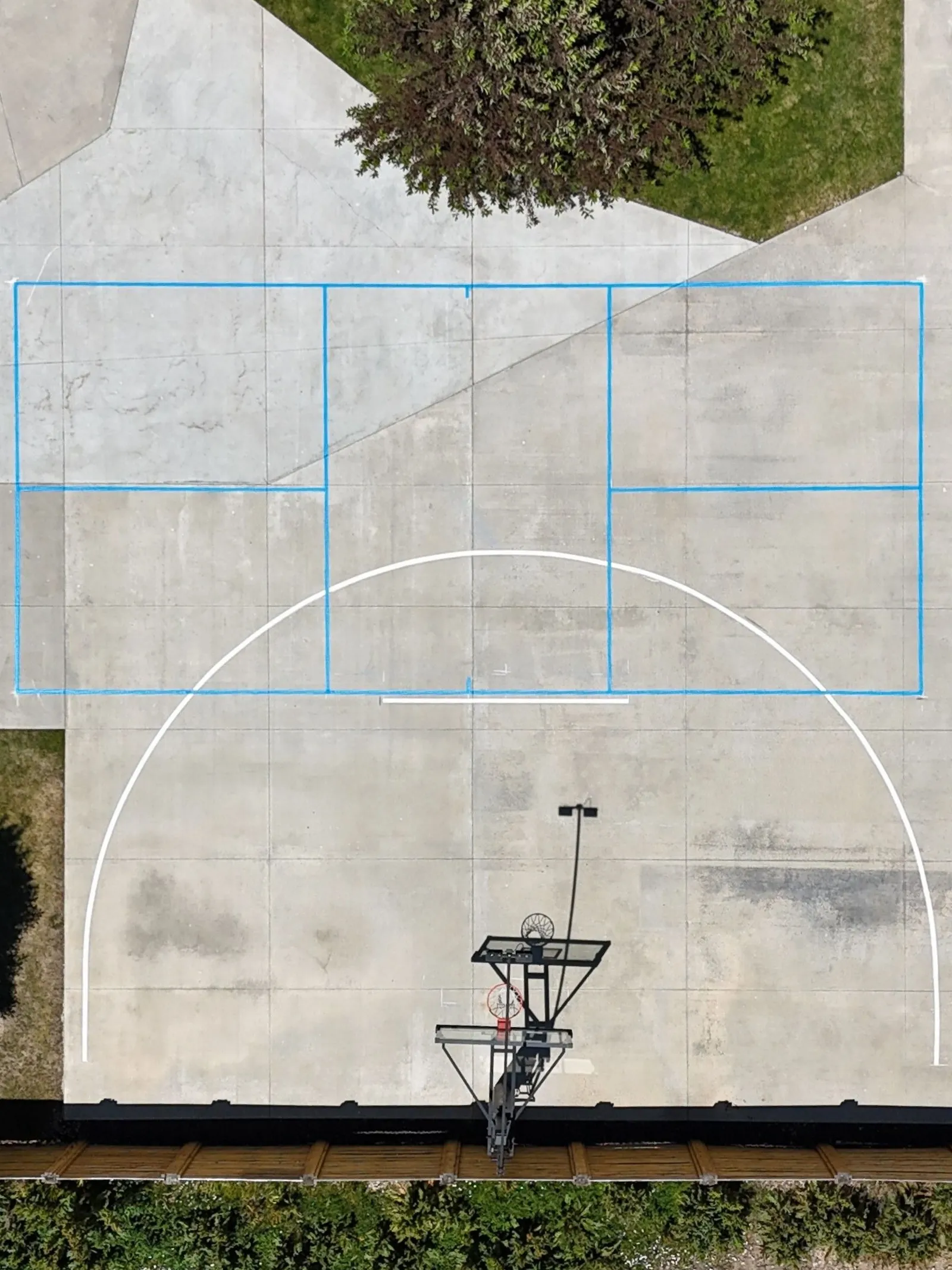 Aerial view of multi-sport court lines on a concrete pad