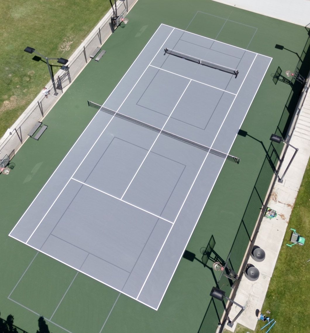 The same court after resurfacing by Grit Courts, gray and green surface