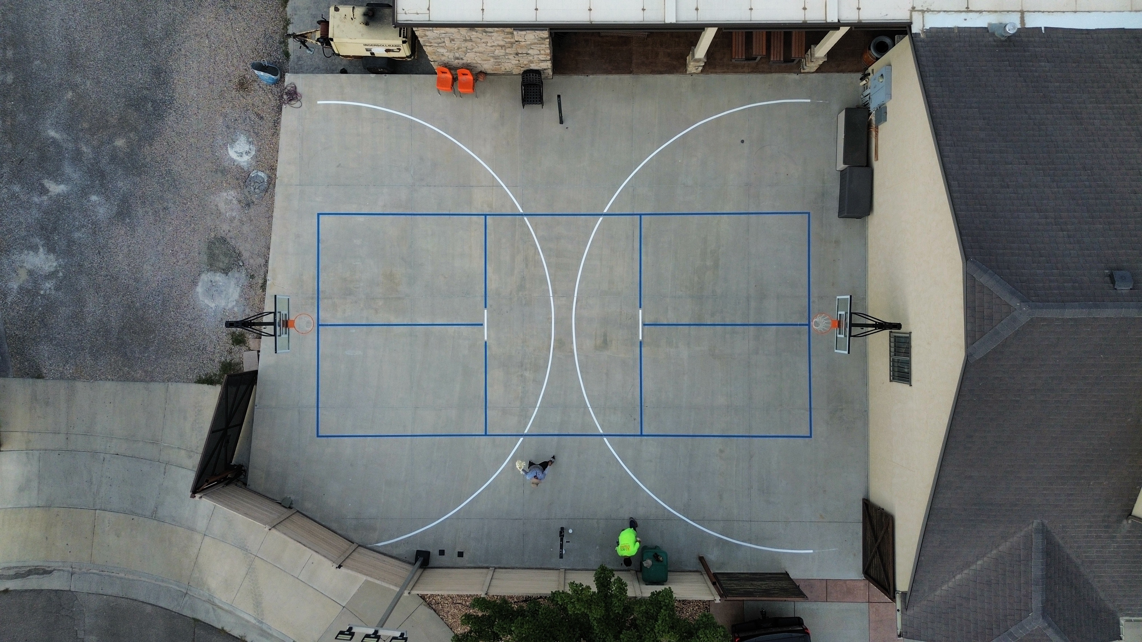 Aerial view of pickleball lines striped on a backyard concrete court